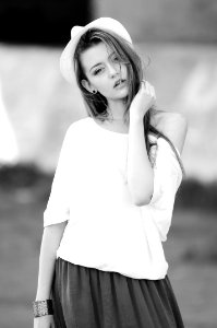 Woman Wearing White Off Shoulder Top In Gray Scale photo