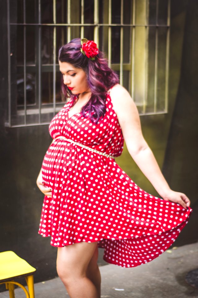 Woman In Red And White Polka Dots Mini Dress Holding Her Stomach