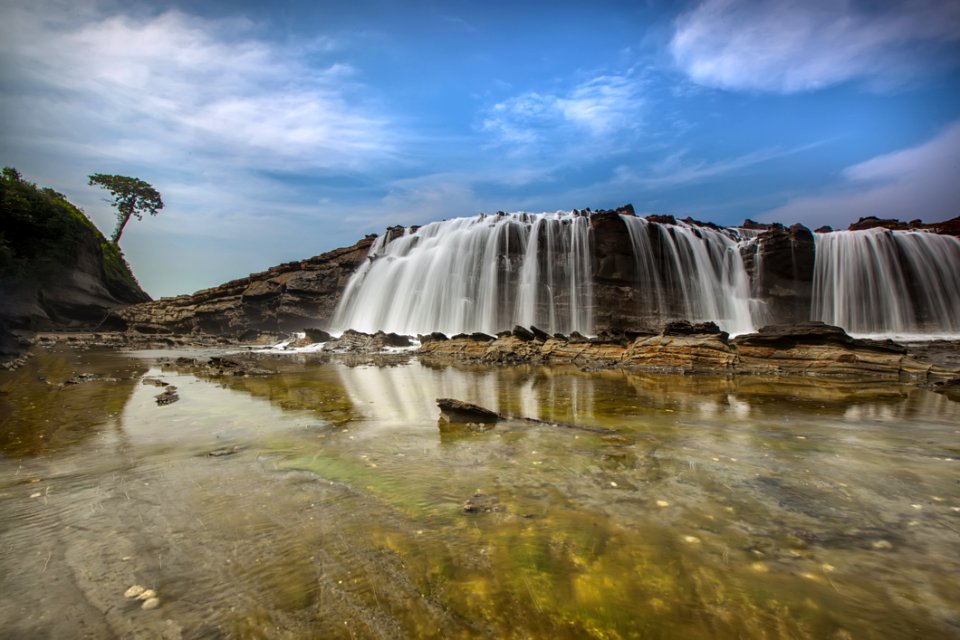 Waterfalls Near Hills Under Blue Sky And White Clouds