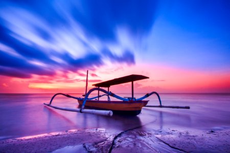 Brown Blue And White Wooden Boat During Orange Sunset photo