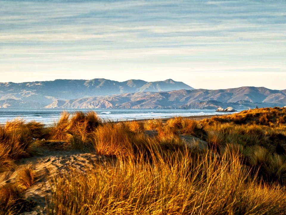Brown Grass Near Mountains During Daytime