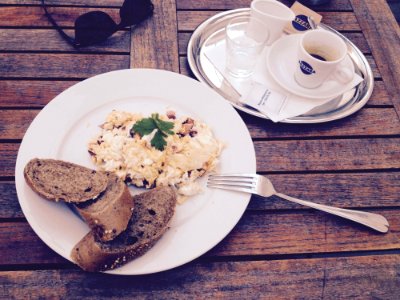Stainless Steel Fork And White Ceramic Plate With Food On Top On Brown Wooden Table
