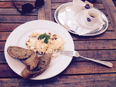 Stainless Steel Fork And White Ceramic Plate With Food On Top On Brown Wooden Table photo