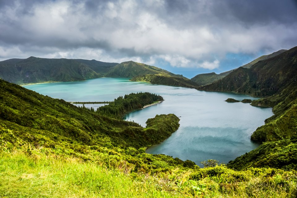 Blue Lake Behind Green Mountain Under White Clouds