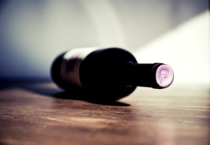 White Labeled Bottle On Brown Wooden Surface photo