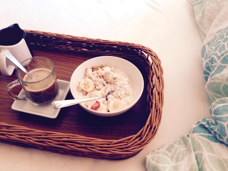 White Round Bowl With Rice And Sliced Bananas Near Clear Glass Mug On Square Ceramic Plate And White And Black Ceramic Mug On Brow