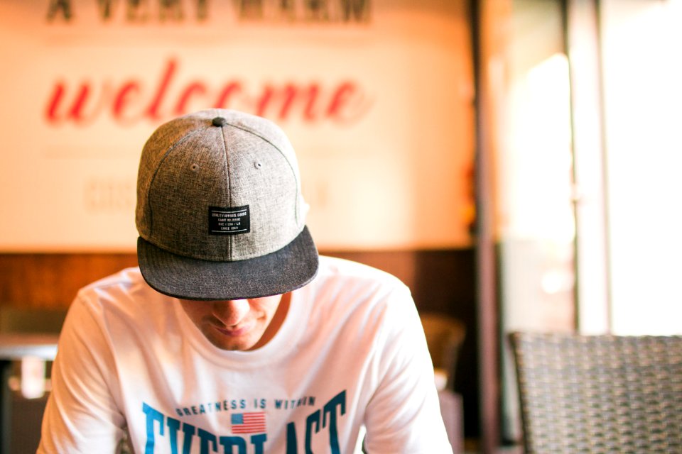 Man In White Crew Neck T Shirt Sitting