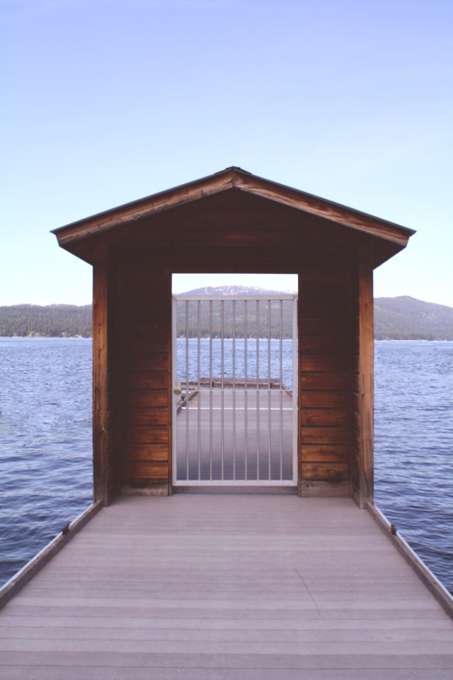 Brown Wooden Dock With White Metal Fence
