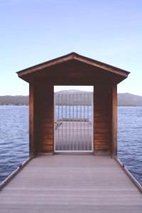 Brown Wooden Dock With White Metal Fence photo