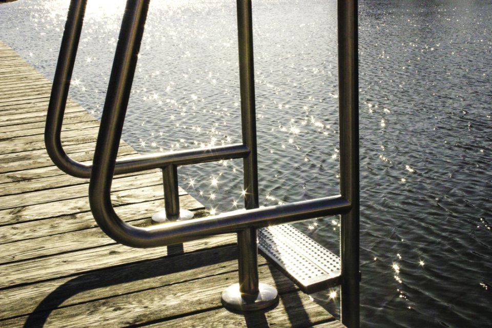 Ladder On Wooden Dock By Sea