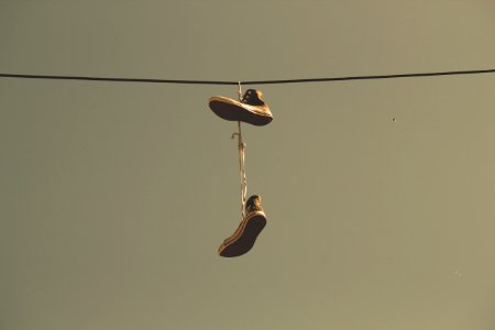 White Black High Top Shoes Hanging On Electric Line photo