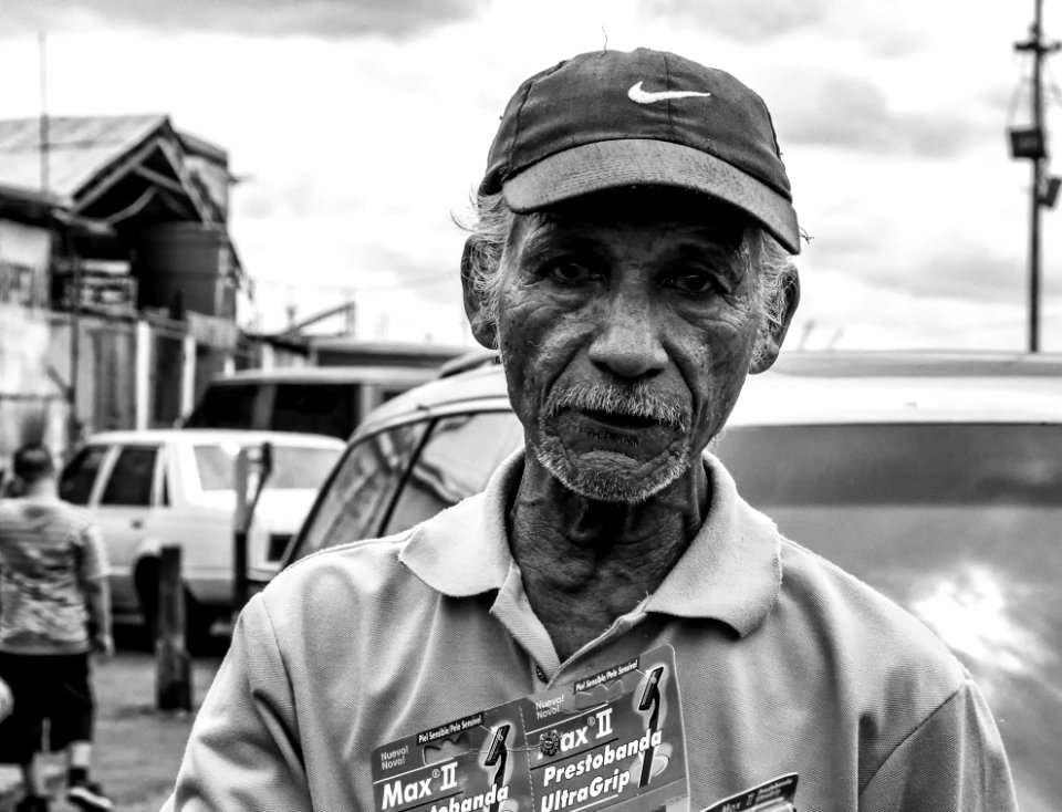 Grayscale Photography Of Man Wearing Polo Shirt And Nike Cap photo