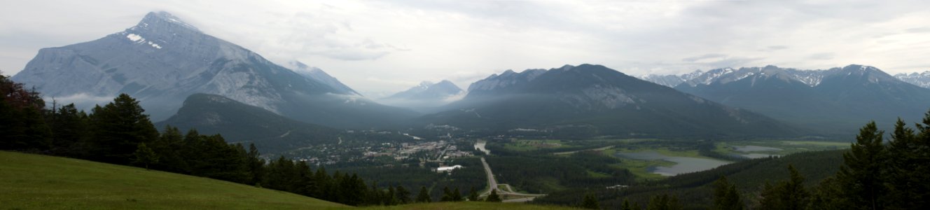 Mountains In The Background And Green Meadows During Daytime