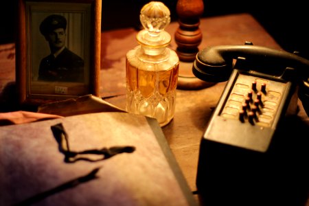 Black And Gray Vintage Telephone Near Glass Perfume Bottle