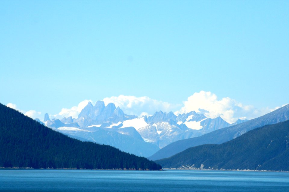 Mountain With Snow Cap Under Cloudy Sky At Daytime