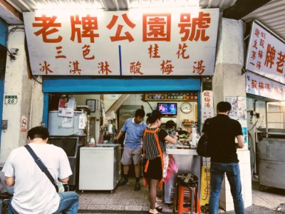 Person In Black Shirt Standing In Front Of Store photo