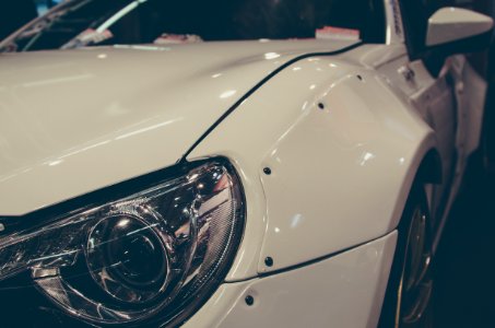 Close View Of White Cars Left Headlight
