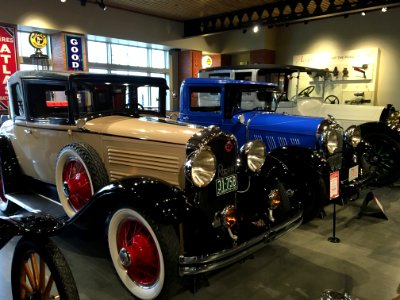 Assorted Vintage Cars In A Well Lighted Room photo