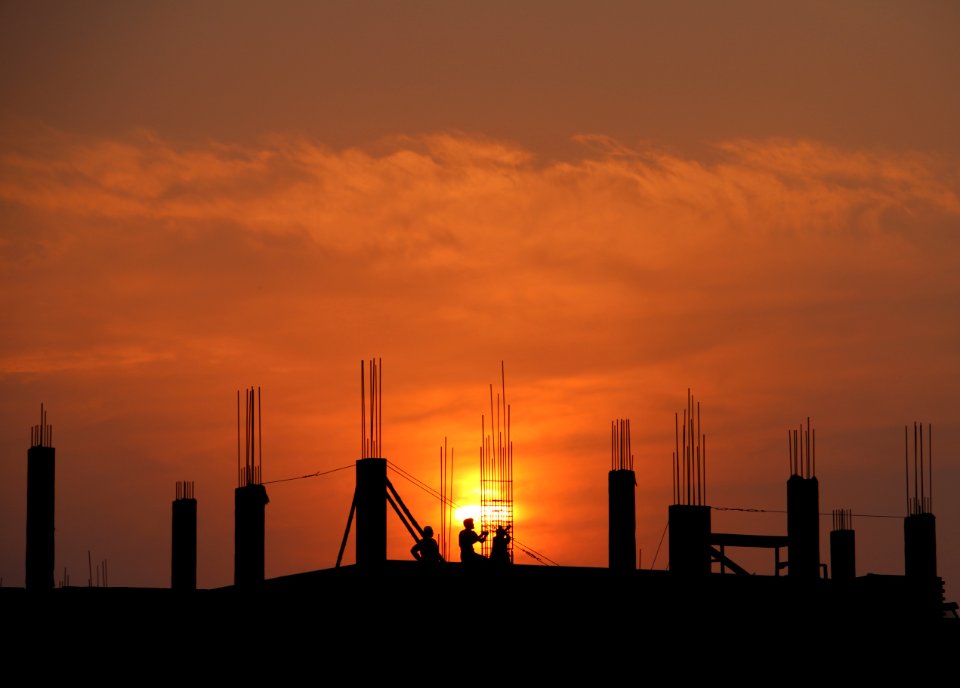 Silhouette Of Men In Construction Site During Sunset