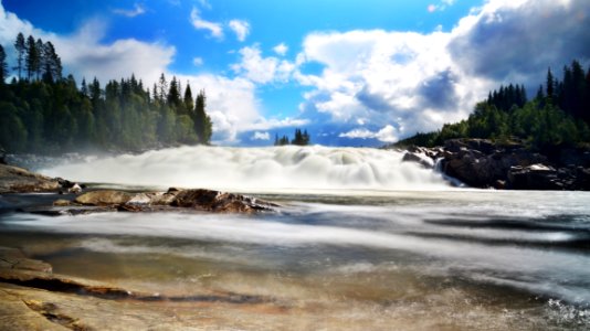 River Near Trees Under Blue Sky And White Clouds photo