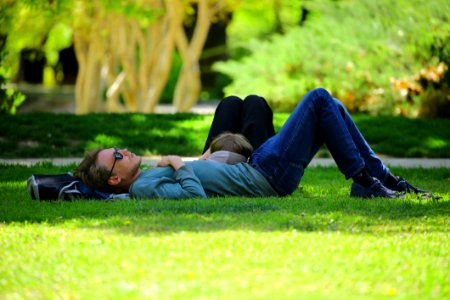 Man Wearing Blue Long Sleeve Shirt Lying On Ground During Daytime photo