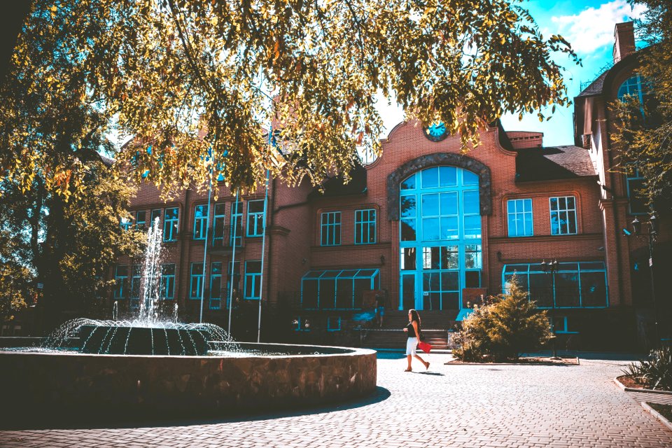 Woman Passing By Near Building During Daytime