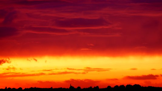 Silhouette Of Trees Under Orange And Red Sky