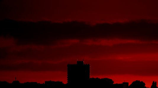 Silhouette Of Building Structures Against Red Skies