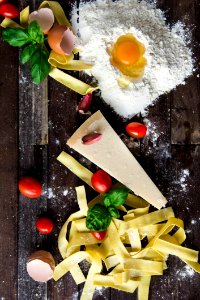 Pasta Tomatoes And Flour With Egg Shells On Table