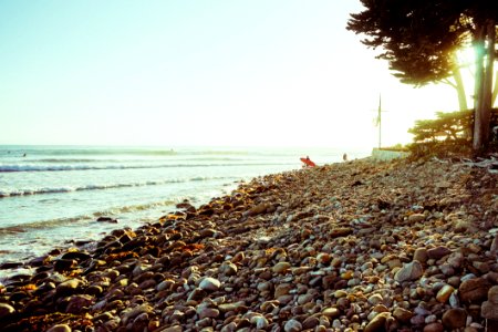 Surfer On Rocky Coast