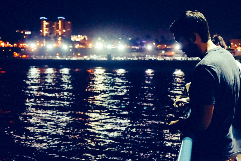 Man Fishing At Night