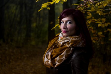 Woman Wearing Brown And White Scarf Surrounded By Trees At Daytime photo