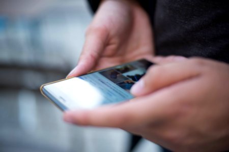 Person Using Smartphone Shallow Focus Photography photo