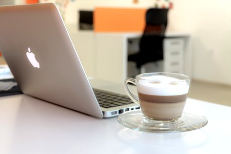 Macbook Pro Besides Clear Glass Mug