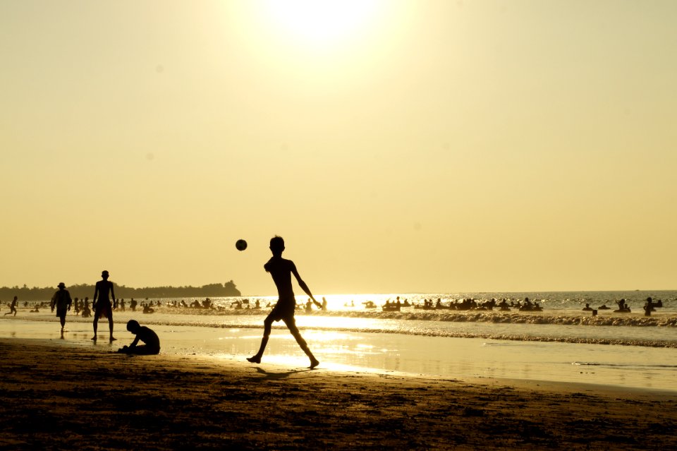 Silluhette Of Man Playing Ball Near The Seashore