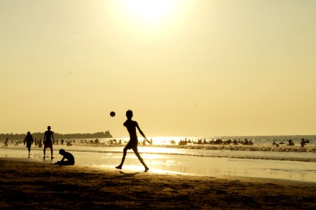 Silluhette Of Man Playing Ball Near The Seashore