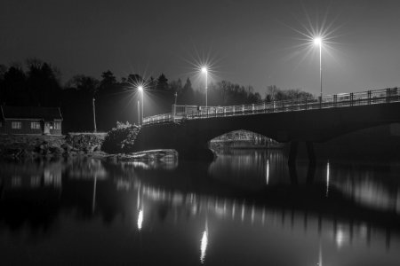 Grayscale Photo Of Bridge At Night photo
