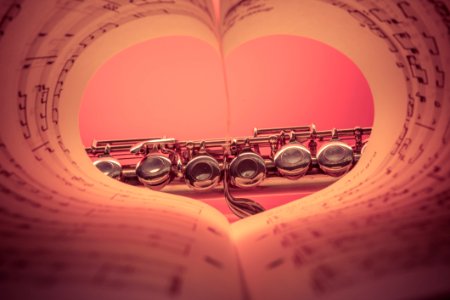 Chrome Musical Instrument Viewed On Heart Shaped Music Score Book