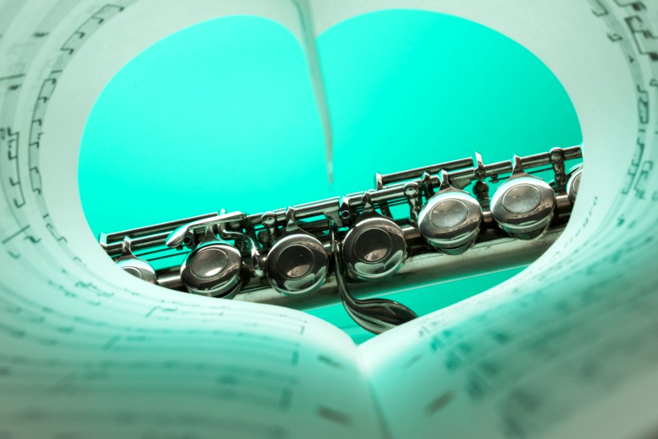 Music Note Book And Silver Soprano Flute Close Up Photography