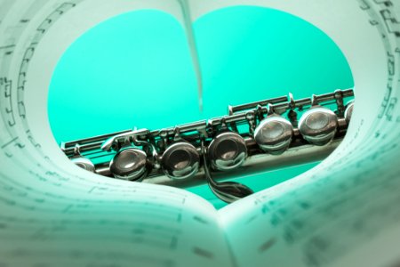 Music Note Book And Silver Soprano Flute Close Up Photography