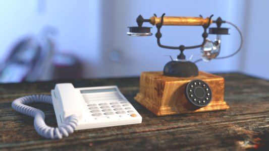 White Electric Home Phone Close To Rotary Phone On Table