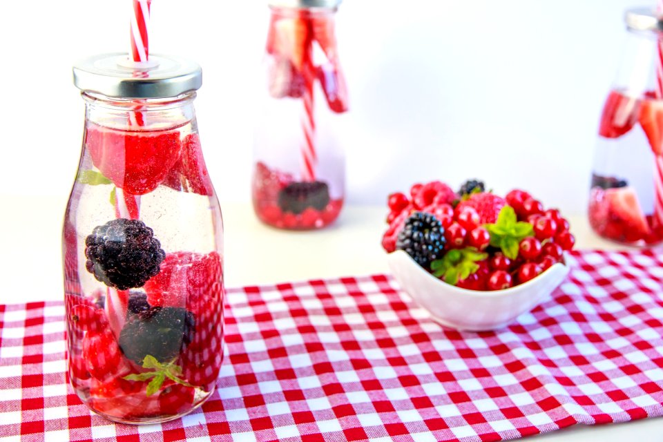 Red Cherry And Grapes On Clear Glass Bottle photo