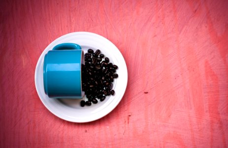 Blue Ceramic Tea Cup With Beans On Plate