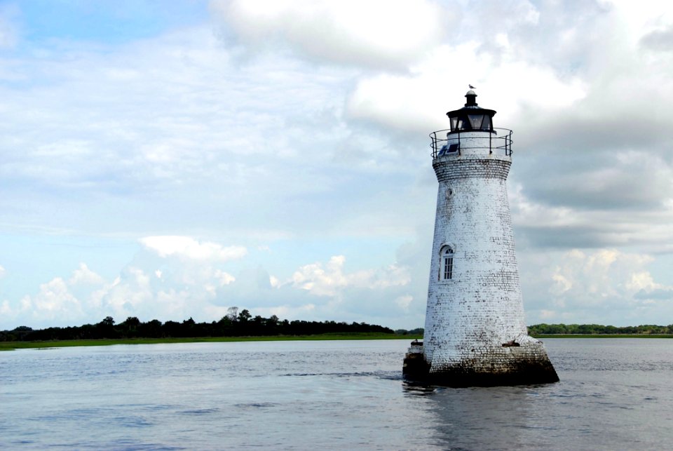 White Light House In The Middle Of Sea