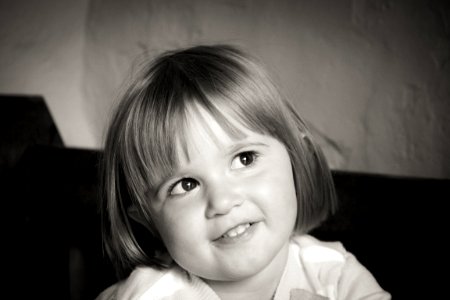 Portrait Of Smiling Girl With Short Hair In Grayscale Photography