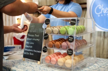 Black Sesame Key Lime Chocolate And Strawberry Macarons In A Glass Display