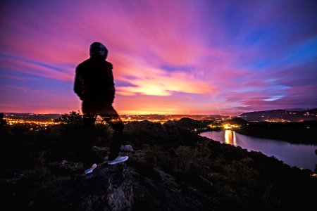 Man On Cliff At Sunset photo