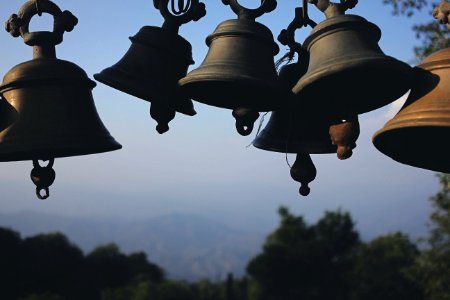 Photography Of Black Hanging Bells During Daytime photo