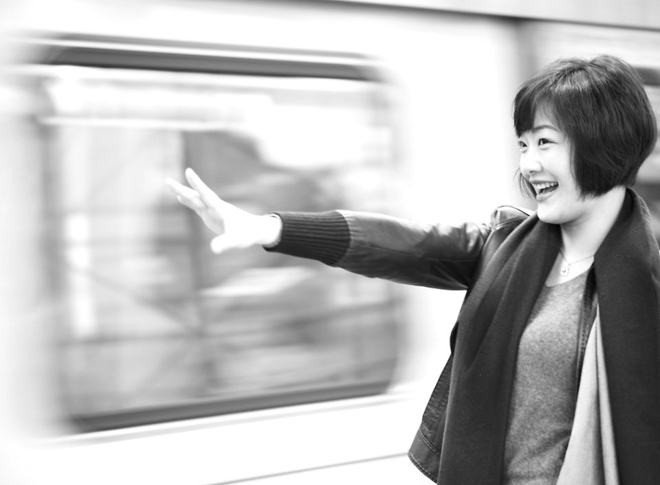 Grayscale Photography Of Woman Raising Right Arm