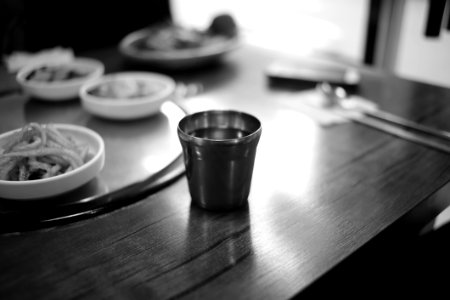 Stainless Steel Cup On Brown Wooden Top Table photo